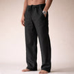 Man wearing black linen drawstring pants with side pocket