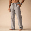 Man wearing gray linen drawstring pants with side pocket