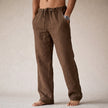 Man wearing brown linen drawstring pants with side pocket