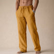 Man wearing gold linen drawstring pants with side pocket