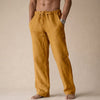 Man wearing gold linen drawstring pants with side pocket