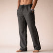 Man wearing dark gray linen drawstring pants with side pocket