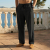 Man wearing black linen drawstring pants standing on a terrace