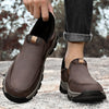 Black leather slip-on shoe with rugged lugged sole, three-quarter view