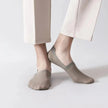 Light grey invisible anti-slip socks on feet - side view showing no-show low-cut design