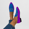 Blue suede-look moccasin flats on a model's feet