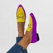 Yellow suede-look moccasin flats on a model's feet