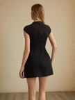 Back view of a black mini dress showing the zip closure and vertical seaming