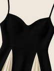Detail of black and cream contrast pleated skirt panels