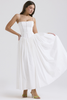 Woman wearing a white corset-style midi dress with gathered skirt