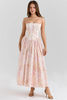 Woman wearing a blush floral corset-style midi dress