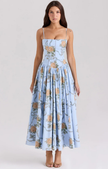 Woman wearing a light blue floral corset-style midi dress
