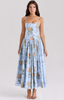 Woman wearing a light blue floral corset-style midi dress