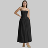 Woman wearing a black corset-style midi dress with gathered skirt