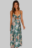 Woman wearing a green floral maxi dress with a tied cutout front