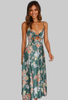 Woman wearing a green floral maxi dress with a tied cutout front