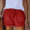 Women's red denim frayed hem shorts with drawstring waist and front patch pockets