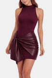 Woman wearing a burgundy mini dress with a knotted faux leather wrap skirt