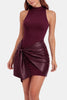 Woman wearing a burgundy mini dress with a knotted faux leather wrap skirt