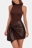 Woman wearing a brown mini dress with a knotted faux leather wrap skirt