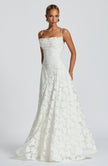 Women in a white spaghetti strap maxi dress - full length elegant front view