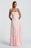 Women in a pink spaghetti strap maxi dress - full length front view