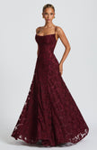 Women in a wine red spaghetti strap maxi dress - full length front view