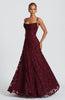 Women in a wine red spaghetti strap maxi dress - full length front view