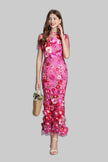 Women's dark pink 3D floral appliqué mermaid maxi gown with ruffled hem on grey background