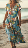 Woman wearing a teal floral butterfly print dress