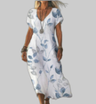 Woman wearing a white dress with blue leaf branch print