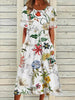 Woman wearing a white midi dress with vibrant colorful botanical floral print and short sleeves