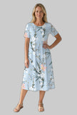 Woman in a light blue floral midi dress with round neckline and short sleeves, front view on gray background