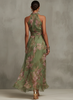 Back view of a green and pink floral halter maxi dress showing the neck clasp and open back