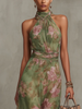 Close-up of the halter neckline with metal clasp detail on a floral maxi dress