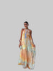 Woman wearing a multicolor watercolor print halter maxi dress with an open back