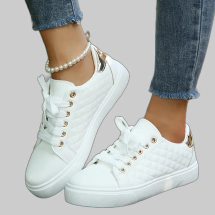 White quilted lace-up platform sneakers on a model's feet
