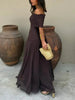 Side view of a woman wearing a brown ruched off-shoulder maxi dress