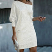 Woman wearing a white off-shoulder sequin mini dress