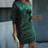 Woman wearing a dark green off-shoulder sequin mini dress