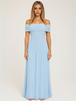 Woman wearing a light blue off-shoulder pleated maxi dress