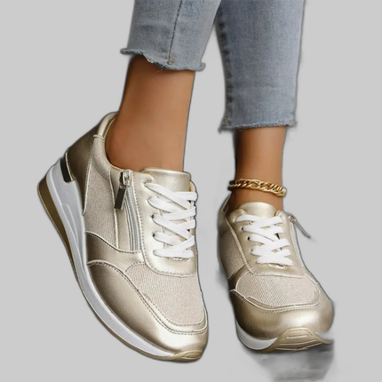 Gold metallic slip-on flat shoe on a model's feet