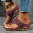 Bordeaux wedge sandal with laser-cut strap worn on a foot