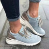 Blue lace-up sneaker with perforated toe and cushioned sole