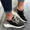 Black lace-up sneaker with perforated toe and cushioned sole