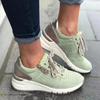 Green lace-up sneaker with perforated toe and cushioned sole