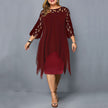 Woman wearing a wine red flowy midi dress