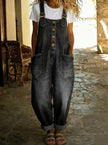 Woman wearing a black denim overall jumpsuit over a white t-shirt
