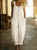 Woman wearing a white denim overall jumpsuit with button-front placket