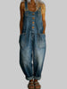 Woman wearing a medium-wash denim overall jumpsuit with buckle straps and front pockets